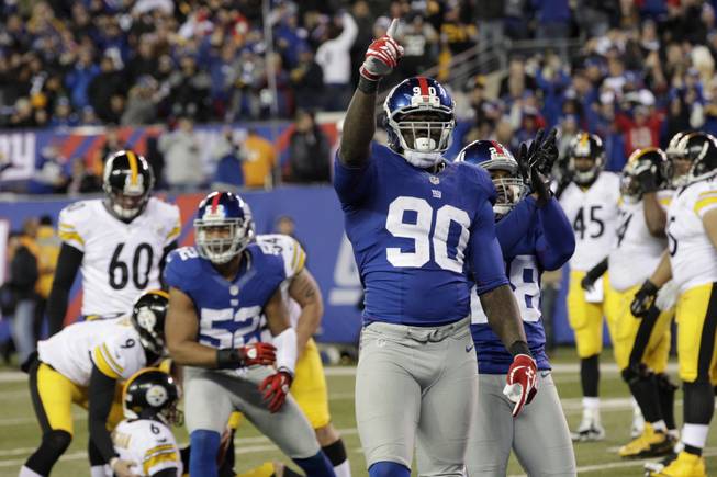 New York Giants defensive end Jason Pierre-Paul (90) reacts after the Giants defense stopped a fake field goal attempt by Pittsburgh Steelers during the second half of an NFL football game Sunday, Nov. 4, 2012 in East Rutherford, N.J. 
