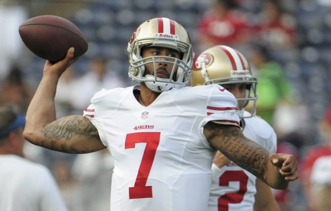 San Francisco 49ers quarterback Colin Kaepernick throws a pass in front of teammate quarterback Colt McCoy, right, during warmups before an NFL preseason game against the San Diego Chargers, Thursday, Aug. 29, 2013, in San Diego. 