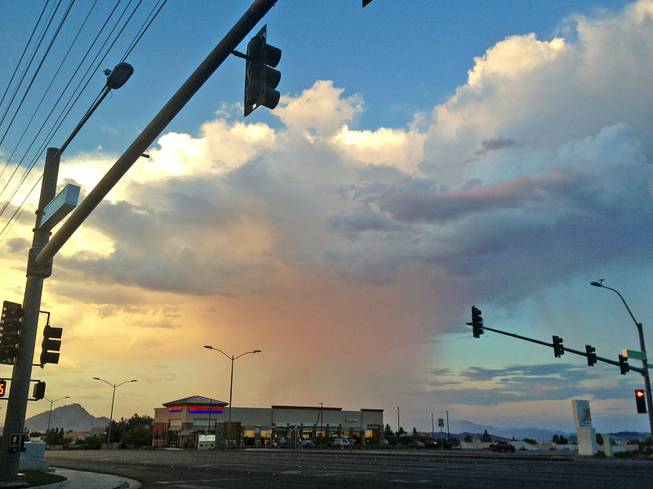 A thunderhead unleashed a shower in the east side of the Las Vegas Valley, as shown looking northeast from the intersection of Stephanie Road and American Pacific Drive in Henderson Thursday evening, Sept. 5, 2013.