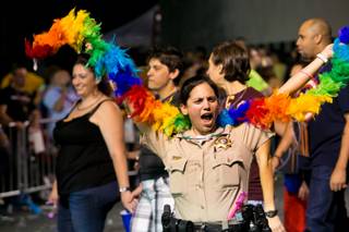 Participants march in the 15th annual PRIDE night parade in downtown Las Vegas, Friday, Sept. 6, 2013.