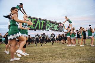 The Green Valley High School football team runs onto the field during the introduction of the Henderson Bowl, Saturday, Sept. 7, 2013. Green Valley beat Basic with a score of 58-36. (Martin S. Fuentes/Las Vegas Sun)