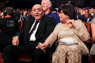 Lois Tarkanian holds her husband Jerry Tarkanian's hand after he was inducted into the Naismith Memorial Basketball Hall of Fame Sunday, Sept. 8, 2013 in Springfield, Mass.