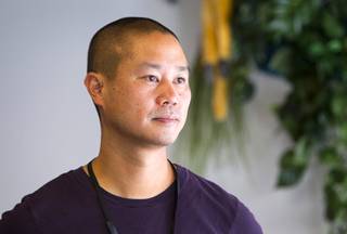 Zappos CEO Tony Hsieh looks out a window from the Monkey Room where he has his office at the new Zappos headquarters in the old city hall building downtown Monday, Sept. 9, 2013. The downtown headquarters officially opened Monday.