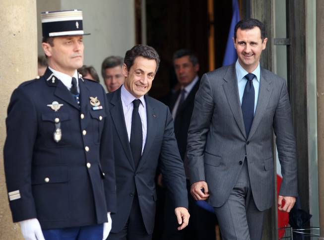 In this Friday, Nov. 13, 2009 file photo, French President Nicolas Sarkozy, second left, escorts Syrian President Bashar Assad, right, following their meeting at the Elysee Palace in Paris.