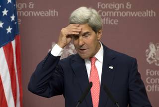 US Secretary of State John Kerry touches his head during a joint press conference with Britain Foreign Secretary William Hague at Foreign Office in London, Monday, Sept. 9, 2013. 