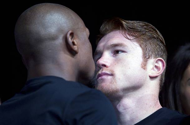 Undefeated boxers Floyd Mayweather Jr., left, and Canelo Alvarez of Mexico face off during a news conference at the MGM Grand Wednesday, Sept. 11, 2013. Mayweather and Alvarez will meet for a WBC/WBA 154-pound title fight at the MGM Grand Garden Arena on Saturday.