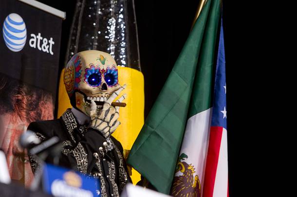 A day of the Dead character waits for the start of a news conference featuring Floyd Mayweather Jr. and Canelo Alvarez of Mexico at the MGM Grand Wednesday, Sept. 11, 2013. Mayweather and Alvarez will meet for a WBC/WBA 154-pound title fight at the MGM Grand Garden Arena on Saturday.