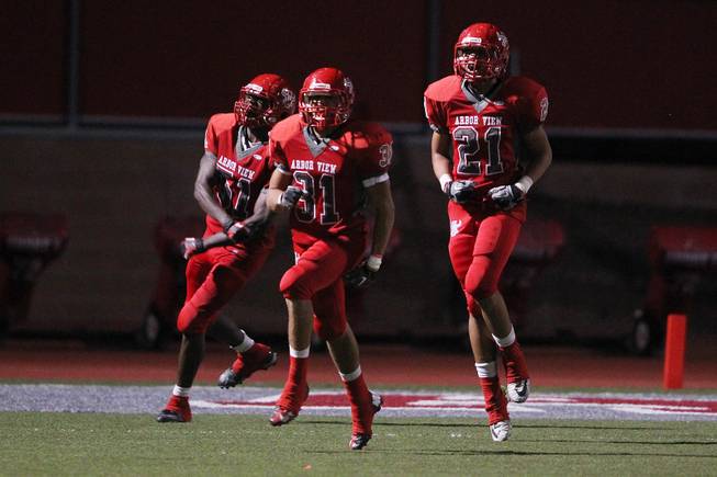 Arbor View's Quamaree Harris, Lonnie Sharpe and Bishop Jones celebrate a touchdown against Centennial during their game Thursday, Sept. 12, 2013. Arbor View cruised to a 35-7 win.