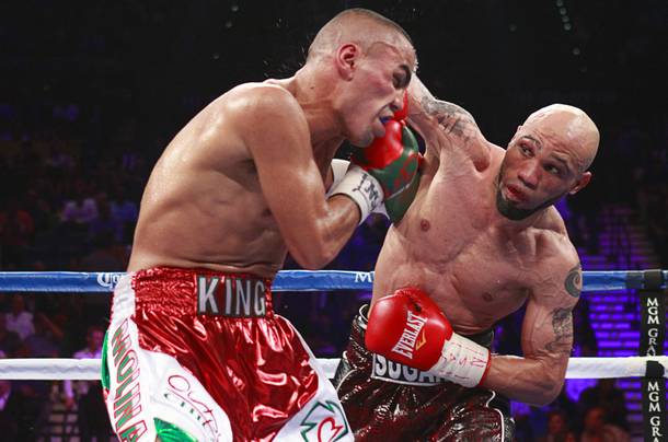 Carlos Molina, left, of Mexico takes a punch from Ishe Smith during their title fight at the MGM Grand Garden Arena Saturday, Sept. 14, 2013.