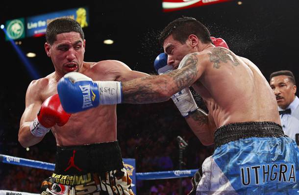 WBC/WBA junior welterweight champion Danny Garcia , left, connects on Lucas Matthysse of Argentina during their title fight at the MGM Grand Garden Arena Saturday, Sept. 14, 2013.
