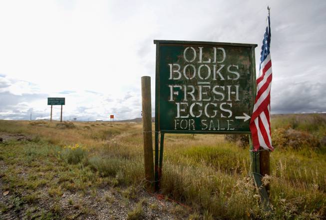 A sign off of Hwy 789 is located at the entrance leading to Mad Dog and The Pilgrim Booksellers in Sweetwater Station, Wyo., Sept. 15, 2013.