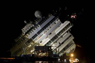 The Costa Concordia ship lies on its side on the Tuscan Island of Giglio, Italy, Monday, Sept. 16, 2013. 