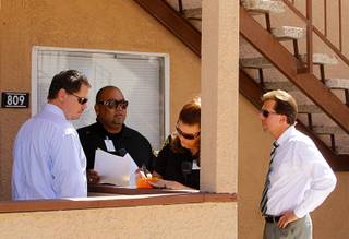 Clark County School Superintendent Pat Skorkowsky, left, attendance officer Javier Morales, senior attendance officer Pam Gunter and Rancho High School principal James Kuzma look for a Rancho High School student at an apartment complex Wednesday, September 18, 2013. They later found out at the apartment office that the family had moved.