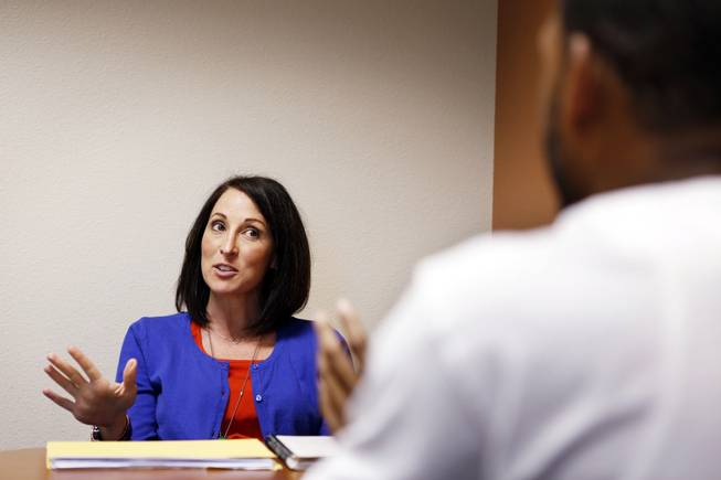 Kisha Earhart, a senior family services specialist with the five-and-under team, speaks with a father regarding an allegation of child abuse that he reported after finding a burn mark on his son, at Clark County's Department of Family Services on Wednesday, Sept. 18, 2013.