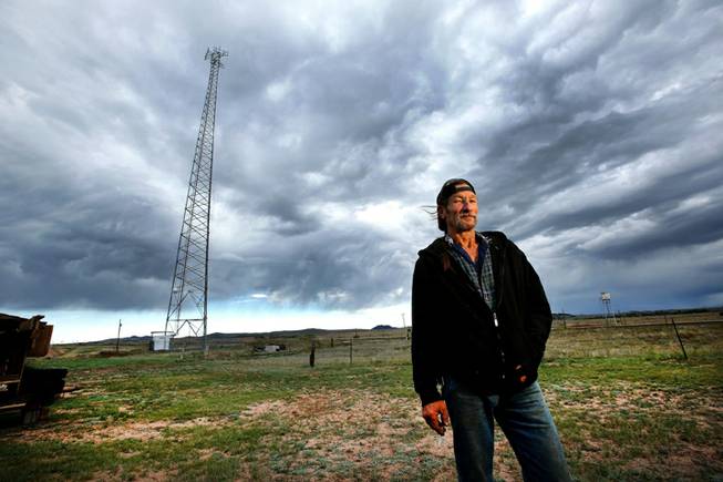 Caretaker Fred Patzer, 55, is photographed in front of a Union Wireless cellular tower located in Buford, Wyoming, September 18, 2013. Patzer is the lone resident of the town consisting of a convenience store, gas station, and modular home on 9.9 acres of land. The town was put up for auction on April 5, 2012, with the highest bid of $900,000 by Vietnamese entrepreneur Pham Dinh Nguyen.