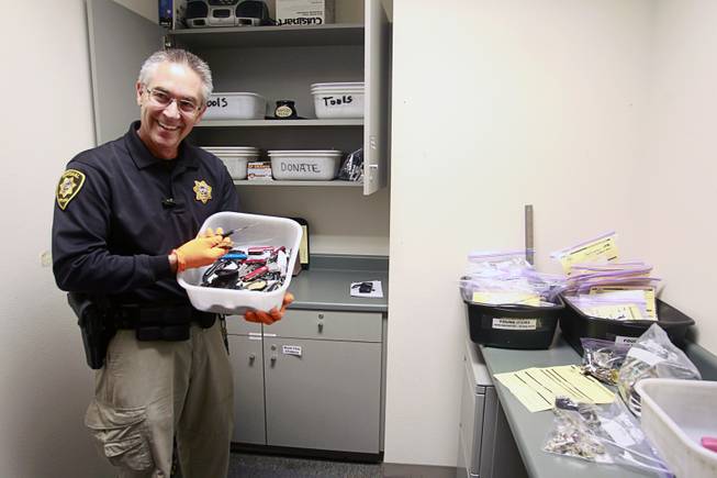 Clark County Deputy Marshal Curt Taylor holds a tray of knives confiscated in September at the Regional Justice Center Thursday, September 19, 2013.