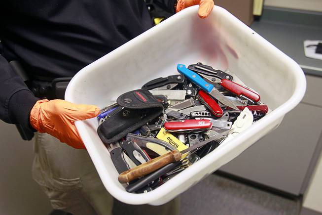 Clark County Deputy Marshal Curt Taylor holds a tray of knives confiscated in September at the Regional Justice Center Thursday, September 19, 2013.