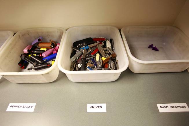 Pepper spray and knives confiscated in September are shown in a back room at the Regional Justice Center Thursday, September 19, 2013.