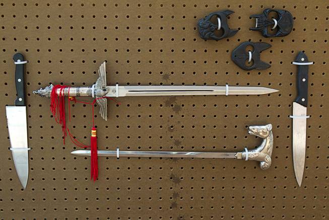 A Nazi replica sword, top, is shown in a display of confiscated weapons and prohibited items at the Regional Justice Center Thursday, September 19, 2013. The lower sword was hidden in a walking cane.