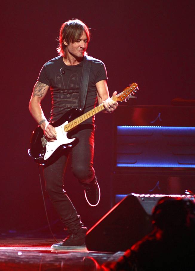 Keith Urban performs during the iHeartRadio Music Festival at the MGM Grand Garden Arena Friday, Sept. 20, 2013.