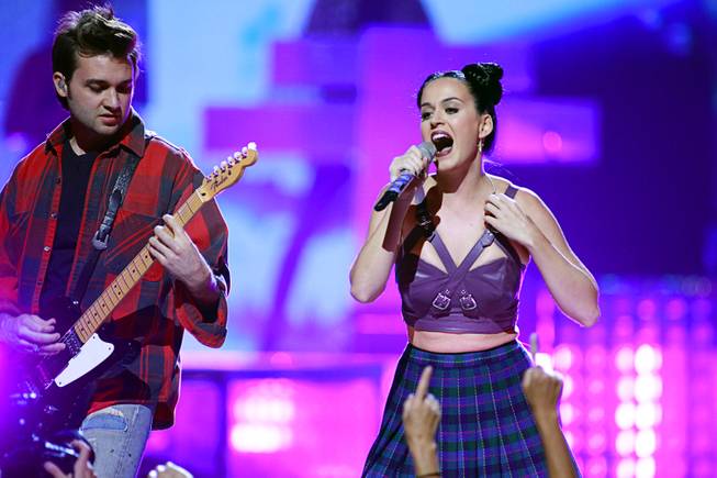 Katy Perry performs with a member of her band during the iHeartRadio Music Festival at MGM Grand Garden Arena on Friday, Sept. 20, 2013.