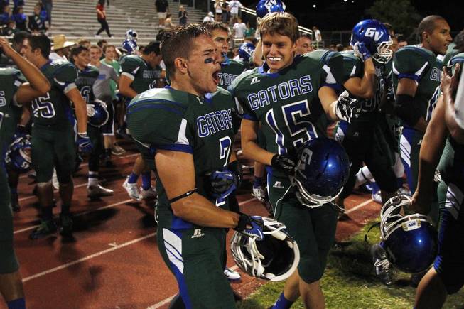 Green Valley players celebrate their win over Palo Verde Friday, Sept. 20, 2013. Green Valley won the game in overtime 42-41.