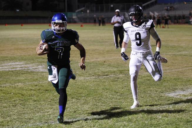 Green Valley quarterback Christian Lopez slips into the end zone past Palo Verde tight end .Jake Ortale during their game Friday, Sept. 20, 2013. Green Valley won the game in overtime 42-41.