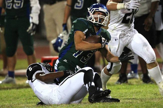 Green Valley wide receiver Kyler Chavez is tackled by Palo Verde defensive back Christopher Johnson during their game Friday, Sept. 20, 2013. Green Valley won the game in overtime 42-41.