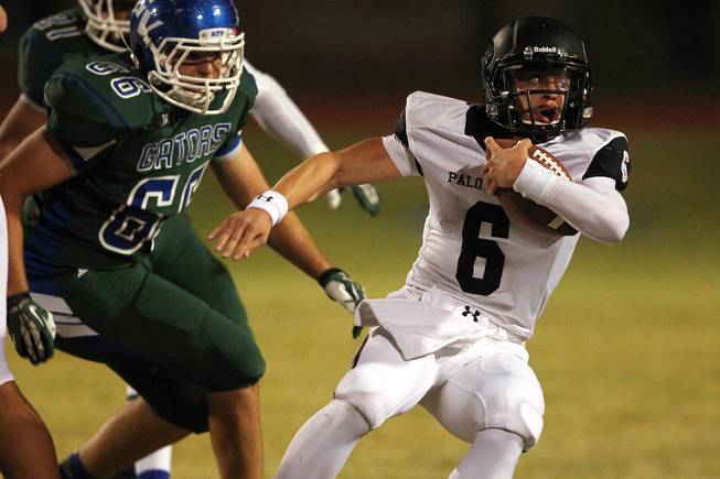 Palo Verde quarterback Parker Rost gets flushed form the pocket by Green Valley defensive end Preston Quirt during their game Friday, Sept. 20, 2013. Green Valley won the game in overtime 42-41.