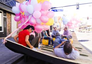 UNLV architecture students and faculty relax on their wood pallet-and-grass parabolic curve on Fremont Street directly south of the El Cortez, Friday, Sept. 20, 2013. They are participating in the day-long Parks,