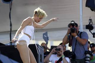 Miley Cyrus dances in the Village across from the Luxor during the 2013 iHeartRadio Music Festival on Saturday, Sept. 21, 2013.