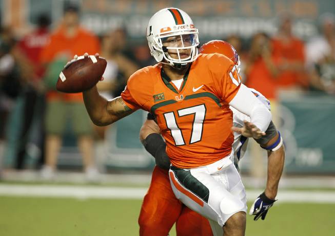 Miami quarterback Stephen Morris passes the football during the first half of an NCAA college football game against Savannah State, Saturday, Sept. 21, 2013, in Miami Gardens, Fla. 