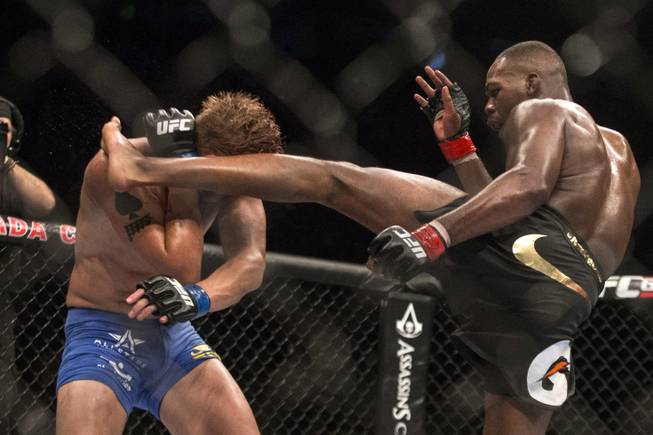American Jon Jones (right) lands a kick on Sweden's Alexander Gustafsson during their World Light Heavyweight Championship bout during UFC 165 in Toronto on Saturday Sept. 21, 2013. (AP Photo/The Canadian Press, Chris Young)