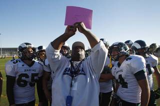 Rancho football coach Tyrone Armstrong calls a play during practice Tuesday, Sept. 24, 2013.