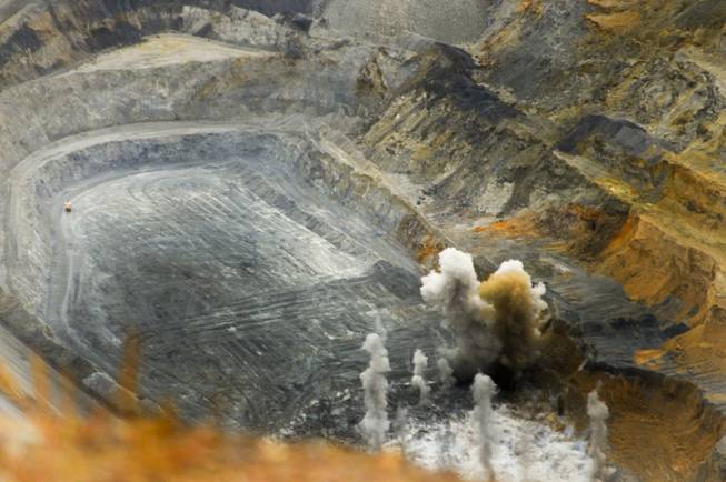 A blast goes off near the bottom of an open pit at Nevada Gold Mines' Carlin Complex west of Elko on Sept. 26, 2013.