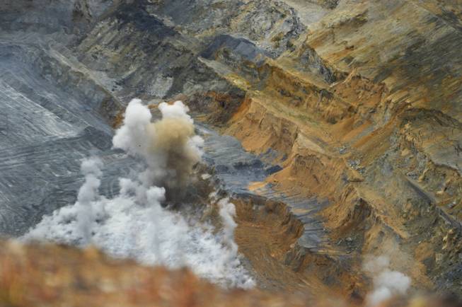 A blast goes off near the bottom of an open pit at the Goldmont Mining Corp.'s Carlin complex wet of Elko on Sept. 26, 2013.