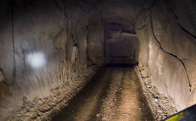 A  tunnel is seen from the back of a vehicle used to haul workers through the Leeville underground mine, operated by the Newmont Mining Corp., on Sept. 26, 2013. The photo was taken about 2,000 feet under ground. light to the left is due to a a mining helmet. 