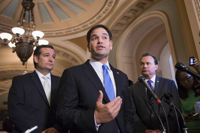 Sen. Marco Rubio, R-Fla., center, accompanied by Sen. Ted Cruz, R-Texas, left, and Sen. Mike Lee, R-Utah, speaks during a news conference on Capitol Hill in Washington, Friday, Sept. 27, 2013, to express their frustration after the Senate passed a bill to fund the government, but stripped it of the defund "Obamacare" language as crafted by House Republicans.
