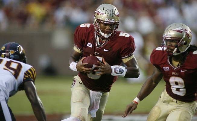 Florida State quarterback Jameis Winston, center, runs in the second quarter of an NCAA college football game against Bethune-Cookman on Saturday, Sept. 21, 2013, in Tallahassee, Fla. 