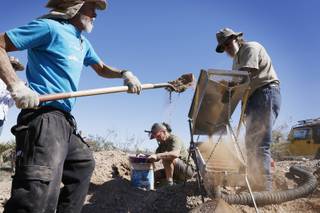 Tony Rhodes, from left, Maria Boyle and Russ Gladen dig and classify dirt during a Gold Searchers of Southern Nevada outing at a claim near Meadview, Ariz. on Saturday, September 28, 2013.