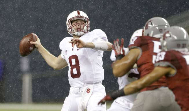 Stanford quarterback Kevin Hogan drops back to pass against Washington State in the second half of an NCAA college football game Saturday, Sept. 28, 2013, in Seattle. Stanford won 55-17.