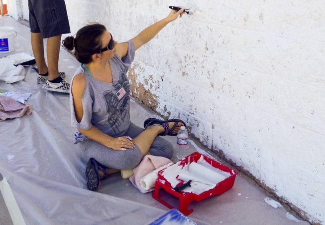 Nicole Phillips paints a wall at the Huntridge Theater on Saturday, Sept. 28, 2013.