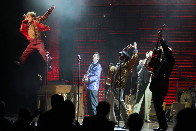 Martin Kaye leaps off a piano while performing as Jerry Lee Lewis during the Million Dollar Quartet show at Harrah's Tuesday, Oct. 1, 2013.