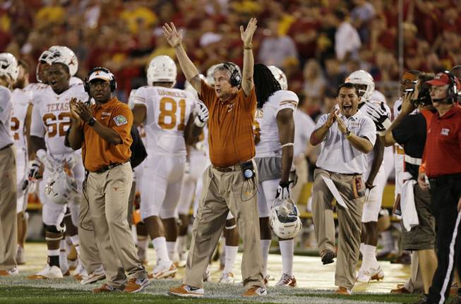 Texas head coach Mack Brown reacts during the first half of an NCAA college football game against Iowa State, Thursday, Oct. 3, 2013, in Ames, Iowa. 