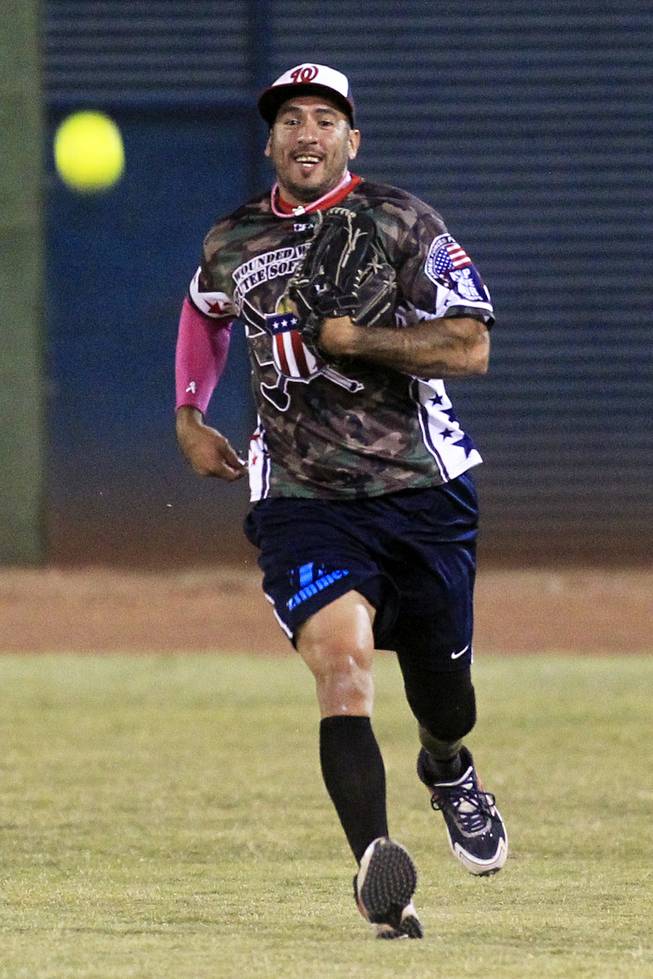 Mike Gallardo of the Wounded Warrior Amputee Softball Team plays an exhibition game with players participating in the LVSSA/SSUSA World Masters Championships softball tournament at the Big League Dreams Park in Las Vegas on Friday, October 4, 2013.