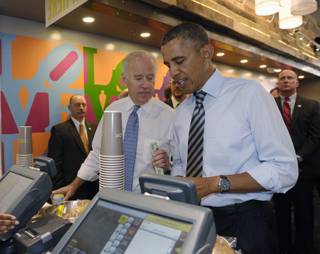 President Barack Obama and Vice President Joe Biden order lunch at Taylor Gourmet sandwich shop near the White House in Washington, Friday, Oct. 4, 2013. The president and vice president stepped out of the White House on a surprise and rare off-campus stroll to grab lunch at a neighborhood eatery. 