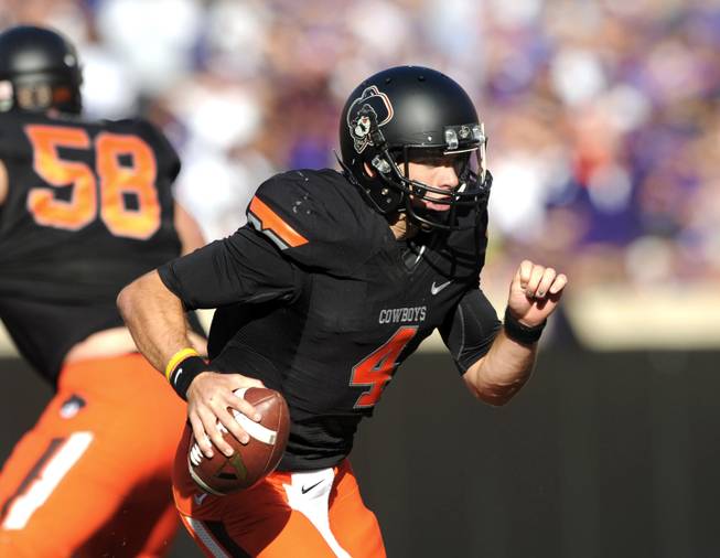 Oklahoma State quarterback J.W. Walsh runs during the second half of an NCAA football game against Kansas State in Stillwater, Okla., Saturday, Oct. 5, 2013. Oklahoma State won 33-29. 