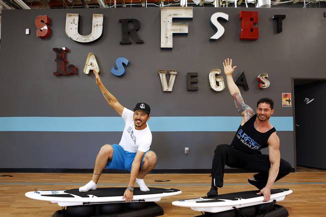 Co-owners Jason Laricchia, left, and Jason Santiago demonstrate some moves on the boards at Surfset Fitness in Las Vegas on Monday, October 7, 2013.