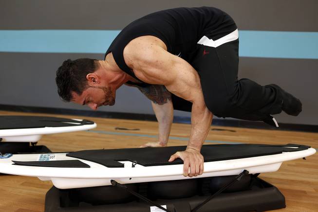 Co-owner Jason Santiago demonstrates an exercise that can be done on the board at Surfset Fitness in Las Vegas on Monday, October 7, 2013.