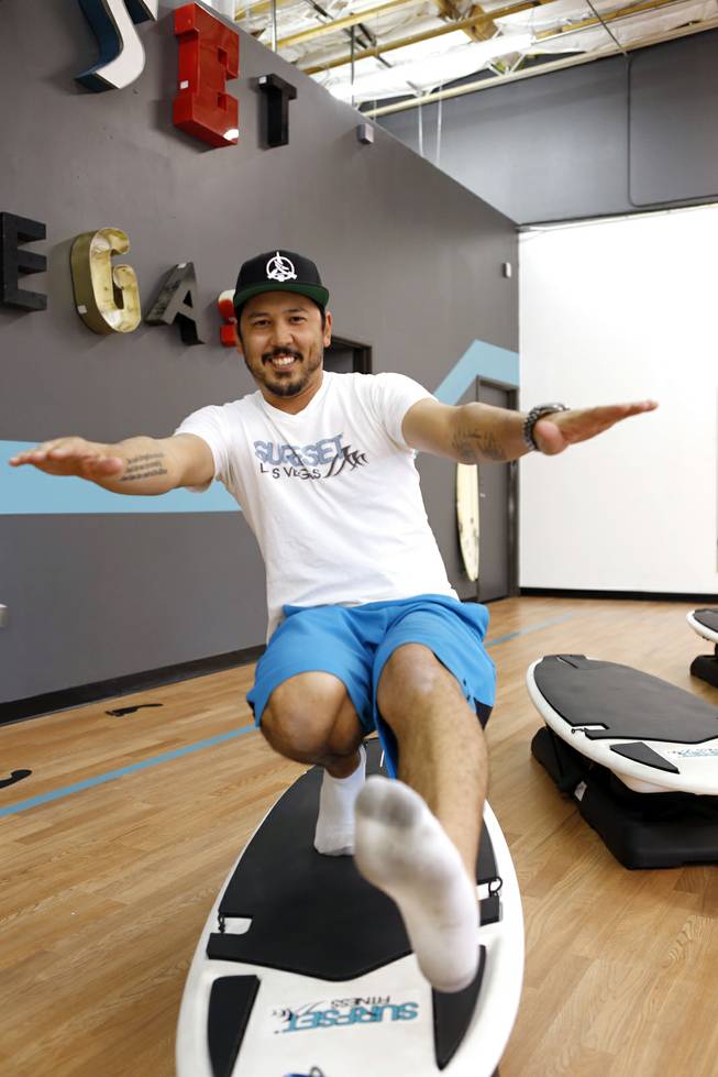 Co-owner Jason Laricchia demonstrates an exercise that can be done on the board at Surfset Fitness in Las Vegas on Monday, October 7, 2013.